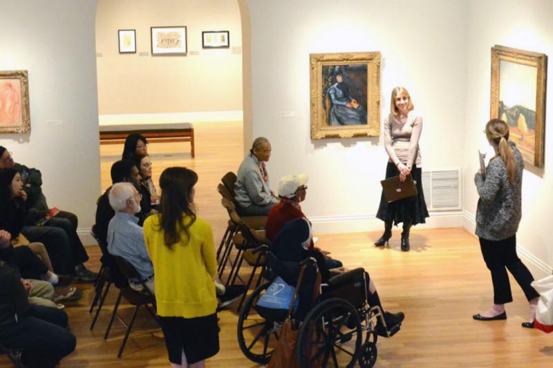 seniors view paintings at the Phillips Collection with GW Art Therapy Program alumnus Hyo Jeong Eun